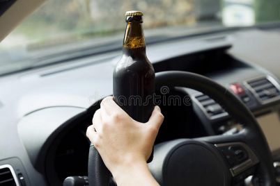 transportation-vehicle-concept-woman-drinking-alcohol-whil-driving-car-121418178.jpg