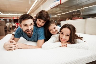 young-happy-family-relaxing-soft-bed-store.jpg